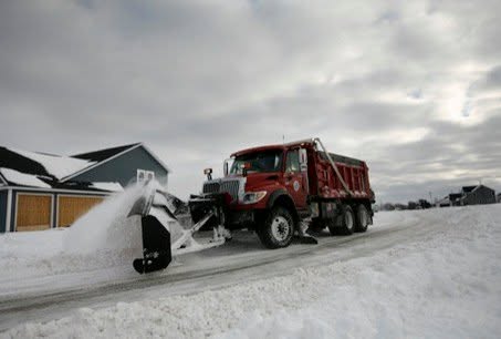 Snow Plow plowing the road